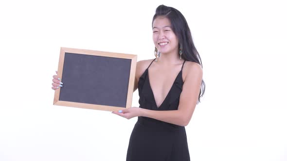 Happy Beautiful Asian Woman Holding Blackboard and Getting Good News