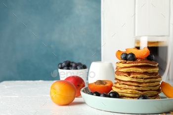 Composition with pancakes and fruits on white table. Sweet breakfast / Photodune, Misc