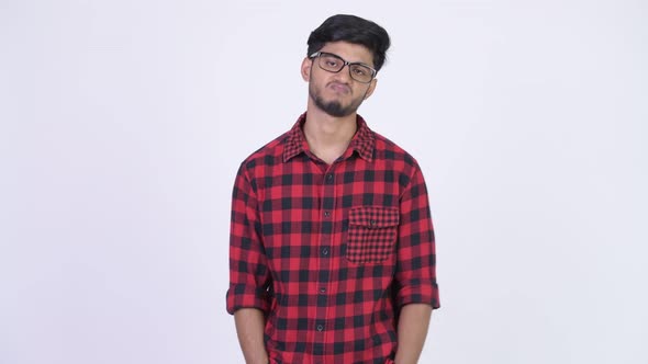 Young Stressed Bearded Indian Hipster Man Looking Bored
