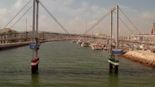 Aerial Shot Dolly Forward Passing Lift Bridge in Lagos Portugal Marina Viewing the Boats and Yachts