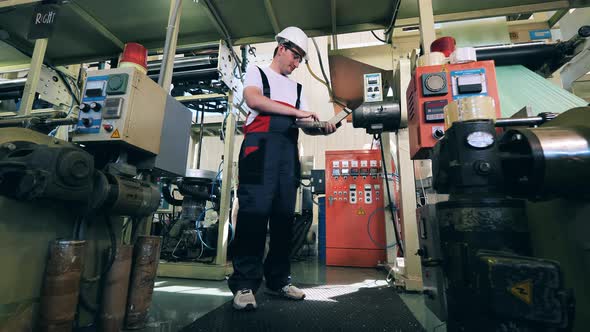 Polyethylene Factory with a Male Engineer Controlling the Work