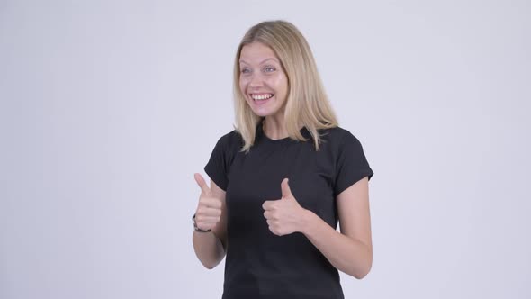 Young Happy Blonde Woman Looking Excited While Giving Thumbs Up