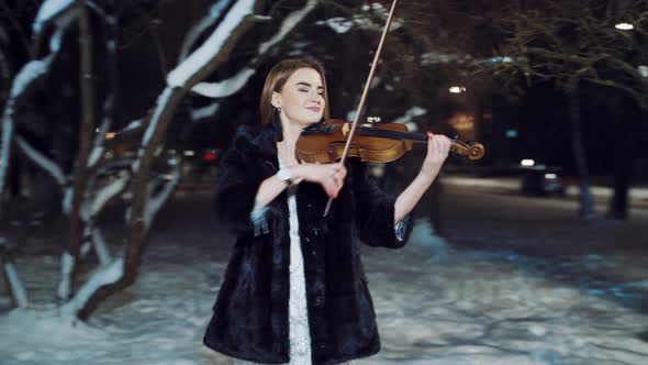 Playing Violin Instrument in the Winter Time