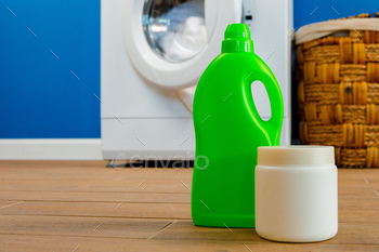 Washing machine with laundry on blue wall background / Photodune, Misc