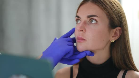 Closeup Young Woman Listening Carefully to Unrecognizable Beautician Sitting in Beauty Salon Looking