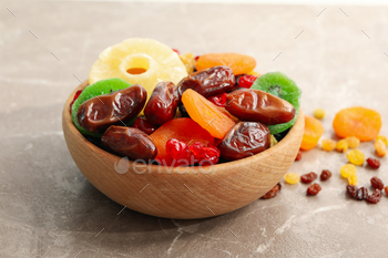 Wooden bowl with dried fruits on gray background / Photodune, Misc