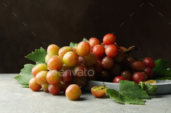 Tray of grape on gray table against brown background / Photodune, Misc