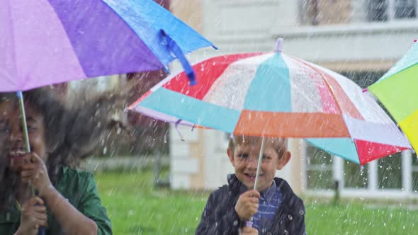 Happy Children Jumping in Rain