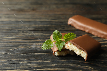 Mint and coconut bars in chocolate on wooden background / Photodune, Misc