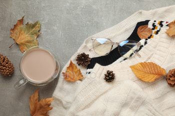 Concept of autumn wear with sweaters and coffee on gray background / Photodune, Misc
