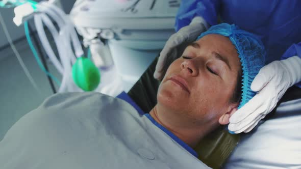 Close-up of Caucasian pregnant woman lying on surgical bed in operation theater 