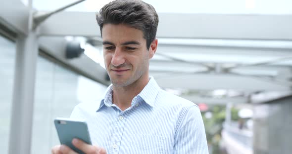 Businessman use of cellphone in Hong Kong city