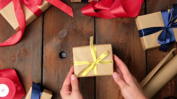 gifts packed in brown kraft paper tied with silk ribbon