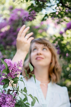 Candid authentic portrait of 30s 40s caucasian blonde woman with lilac flowers. 30 40 year old woman / Photodune, Misc