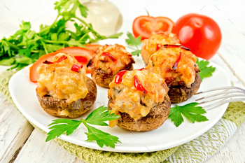 Champignons stuffed meat and pepper in white plate on board / Photodune, Misc