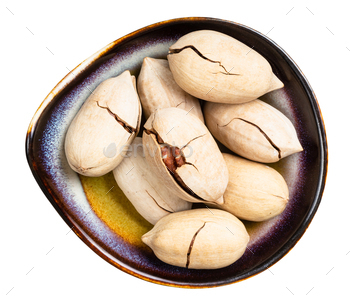 cracked pecan nuts in ceramic bowl isolated / Photodune, Misc