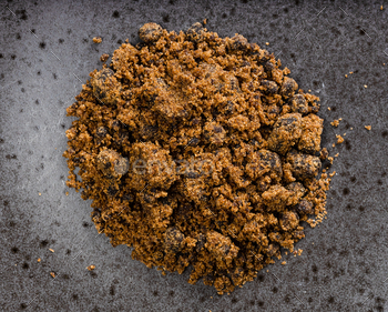 pile of dark muscovado cane sugar closeup on black / Photodune, Misc