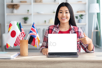 tional Flags And Poiting At Blank White Laptop Screen, Smiling Asian Woman Recommending Website For Learning Foreign Languages Online, Mockup