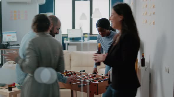 Multi Ethnic People Enjoying Game at Foosball Table