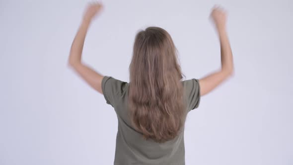 Rear View of Happy Young Woman with Fists Raised