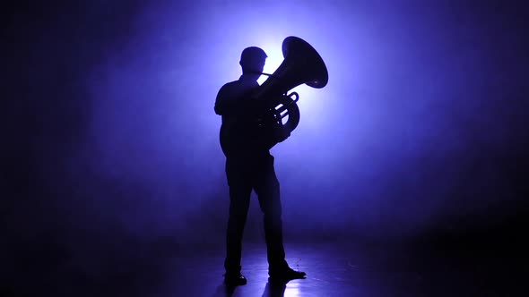 Trumpeter Man in Slow Motion Plays on Tuba, Smoky Studio