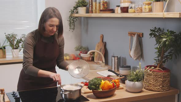 Woman Cooking Pasta in Kitchen