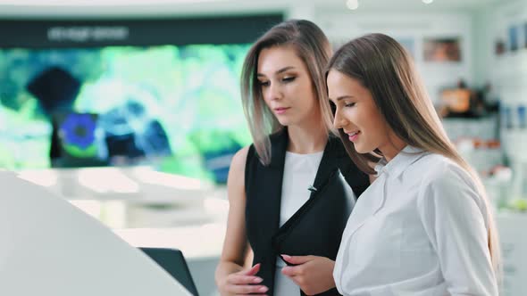 Portrait of Two Attractive European Businesswoman at Hitech Futuristic Exhibition