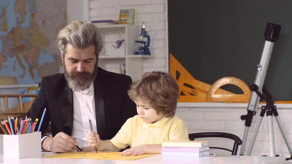 Father and Son at Elementary School. Pupils Education.