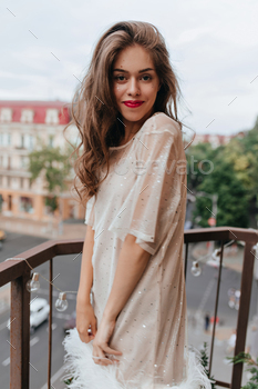 Charming girl in white dress smiles and looks into camera. Portrait of brunette woman with red lips / Photodune, Misc
