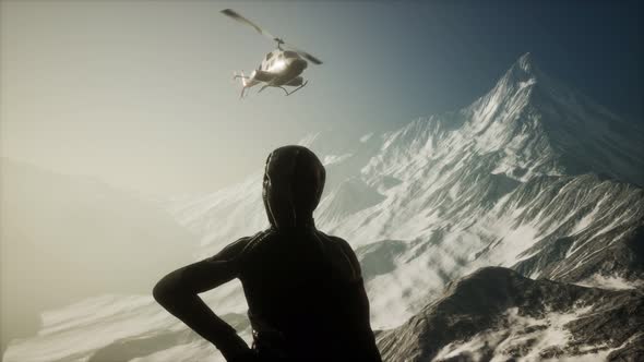 Woman and Helicopter in Winter Mountains