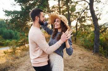 Standing and hugging. Cheerful lovely young couple having a rest outdoors together / Photodune, Misc