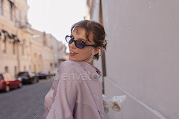Fashion portrait of young lady at light street. Trendy dark-haired girl wearing violet blouse, vint / Photodune, Misc