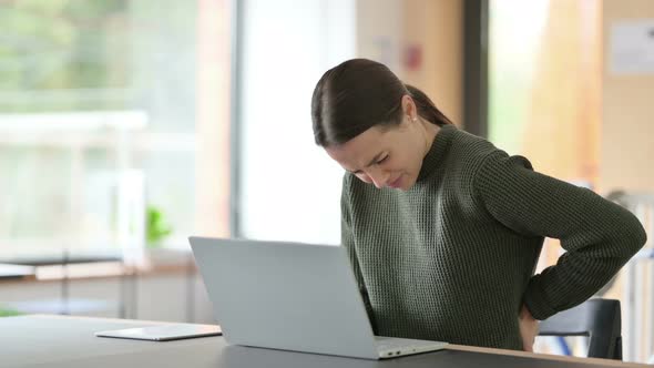 Young Woman with Laptop Having Back Pain 