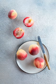 Fresh peaches. Peaches on light concrete background. Flat lay, top view. / Photodune, Misc