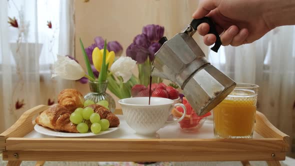 Close Up of a Wood Tray with Breakfast Man Pour Coffee Into Cups