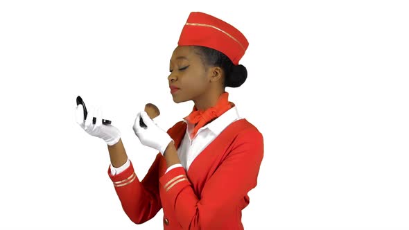 Stewardess Afro American Looks in the Mirror and Paints Her Face with Blushes. Alpha Channel