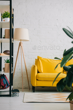 light living room with yellow sofa, rack, carpet on floor and floor lamp / Photodune, Misc