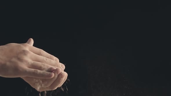 Closeup of Male Hands Shaking Off Flour