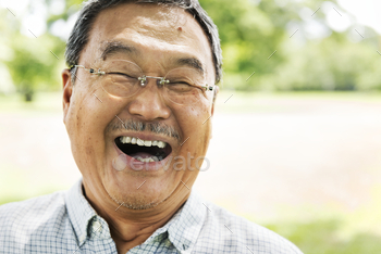Closeup of a Japanese man smiling in a park / Photodune, Misc