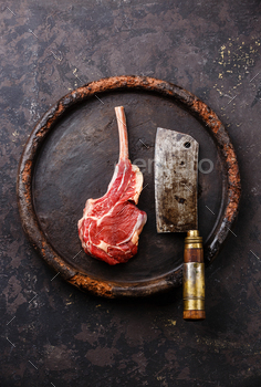 Raw fresh meat Veal rib and Meat cleaver on stone plate on dark background / Photodune, Misc