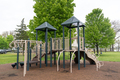 Children playground in public park surrounded by green trees - PhotoDune Item for Sale