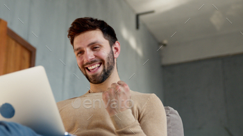 appy emotional man with laptop at work