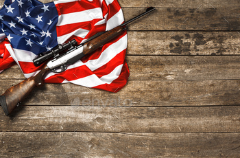 Automatic rifle on USA flag on wooden background / Photodune, Misc