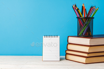 Cup of color pencils and stack of books / Photodune, Misc