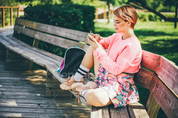 Young Woman Using Mobile Phone In Park. / Photodune, Misc