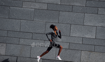 Active runner. Young african american woman in sportive clothes have workout outdoors at daytime / Photodune, Misc