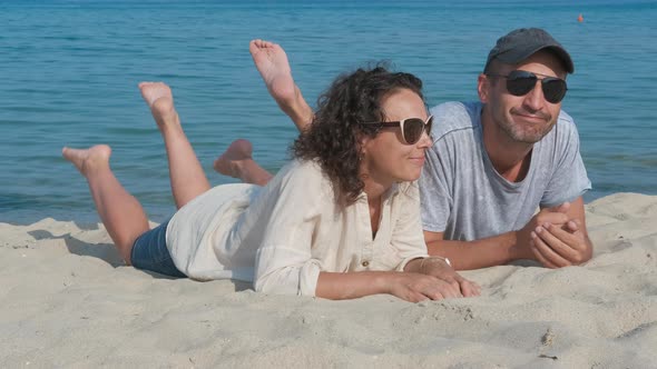 Couple in sunglasses on the beach.