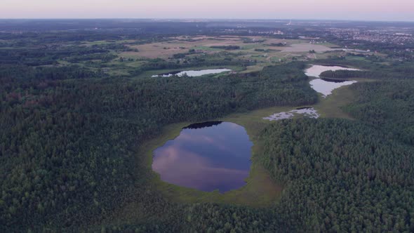 Aerial photography of the lake swamp from a drone at sunset with beautiful sun flares. reflection of