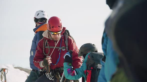 Climber Helps His Friend and Fastens To His Carbine and Checks the Mount. the Whole Group Is