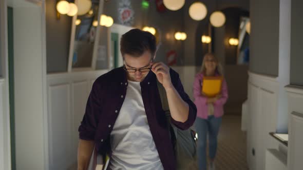 Happy Hipster Male Student Walking and Dancing in University Corridor